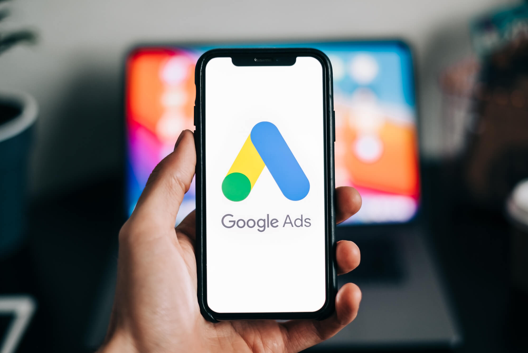 Google ads shown on phone in hand