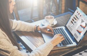 Woman analysing Google PPC results on laptop