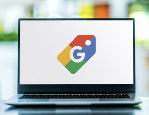 Laptop computer displaying logo of Google Shopping, a service which allows users to search for products on online shopping websites and compare prices between vendors