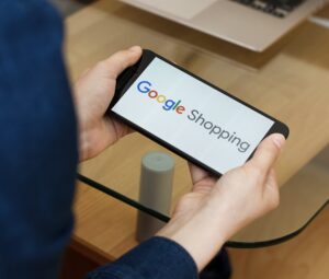 Hands holding smartphone using Google Shopping